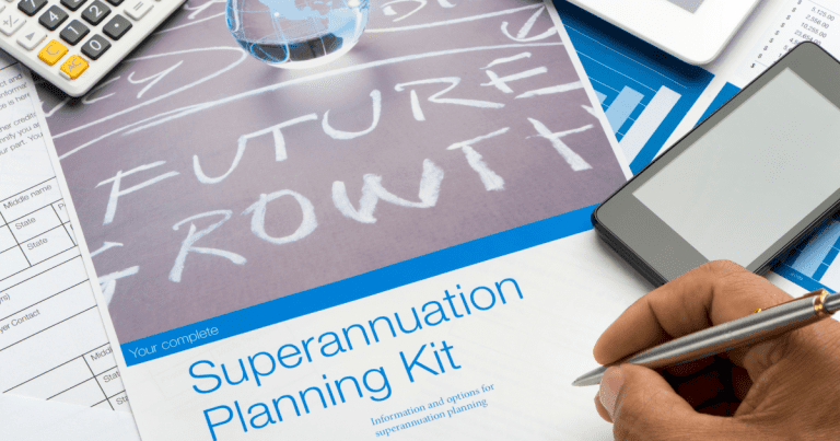 A hand holding a pen over a superannuation planning kit, typically handed over by your chosen accounting firm in Sydney, with a phone, calculator, and globe nearby.