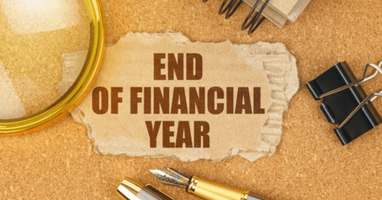 A note with "END OF FINANCIAL YEAR" written on it. Contact our tax accountant near you to make sure your finances are in order.