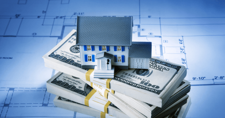 A miniature house placed on top of bundled dollar bills and a blueprint. Contact our accounting firm in Sydney for expert advice on financial planning and investment strategies.