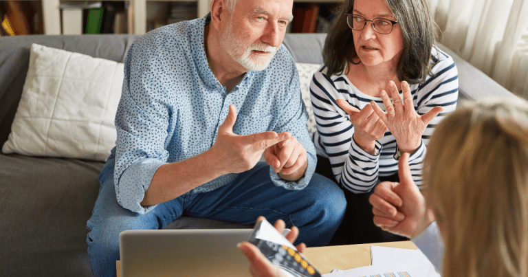 Two elderly individuals meeting with a small business accountant to discuss insurance and financial planning. Contact our tax accountant near you in Sydney for expert financial guidance and compliance with tax regulations.