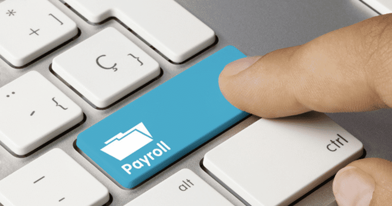 A person's hand hovering over a keyboard with his finger on the "Payroll" button. Contact our small business accountants in Sydney for expert advice on managing your payroll and finances.