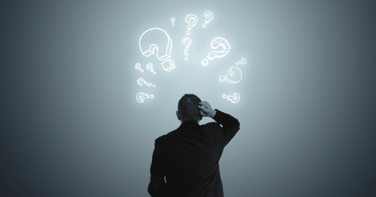 A man on his back, looking confused and scratching his head, with question mark symbols floating above him, perhaps reflecting his need for the expertise and guidance of small business accountants.