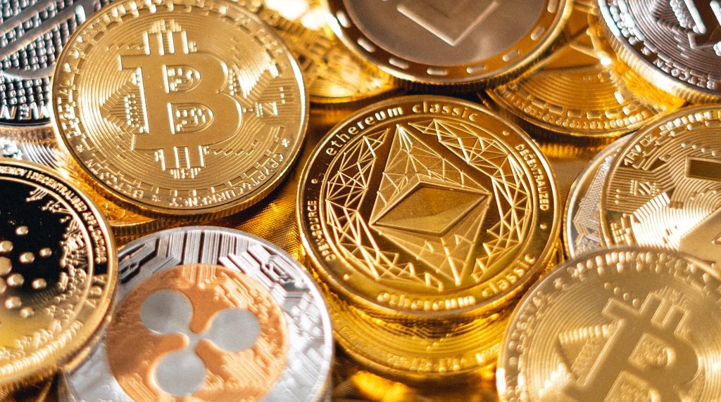 Illustration of various cryptocurrency coins, including Bitcoin, Ethereum, and Litecoin, representing the topic of the Tax Advisor's Guide to Cryptocurrency.