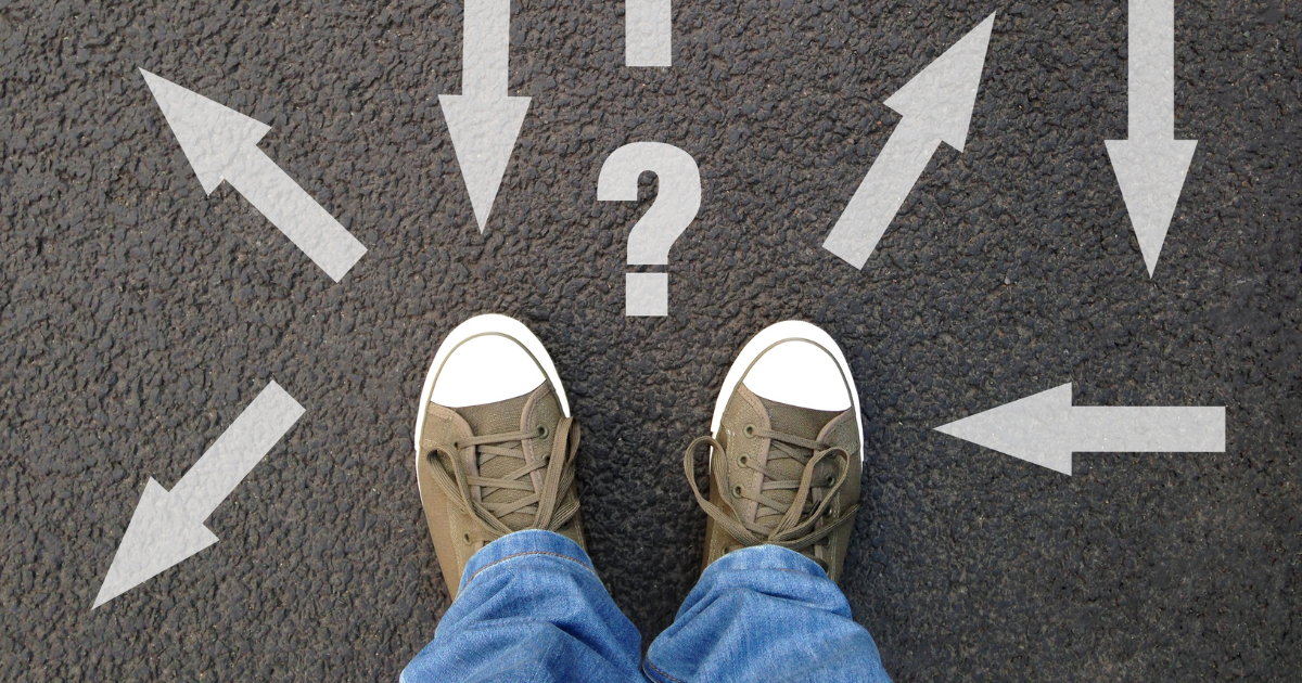 A pair of feet standing on a floor with various directional signs. Contact our accounting firm in Sydney to get guidance and direction for your financial planning and tax preparation needs.