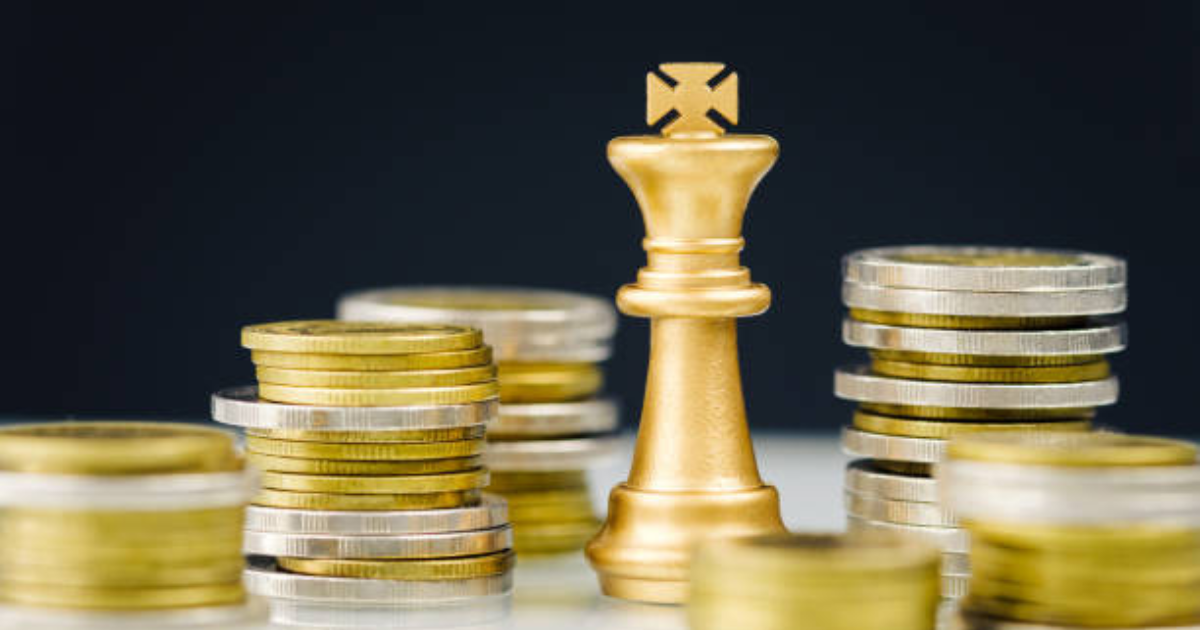 A king chess piece is resting along with piled coins. Let our business accountants in Sydney help you make strategic financial moves.