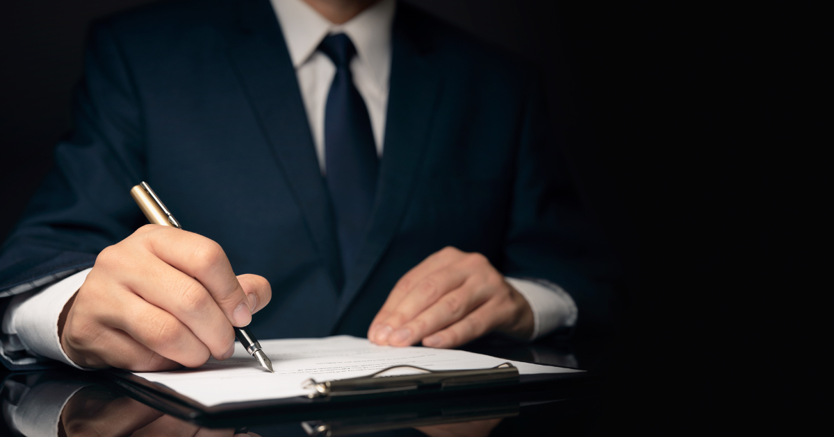 A man signing a legal document with a pen. Trust our accounting firm in Sydney for expert advice on tax planning and preparation.