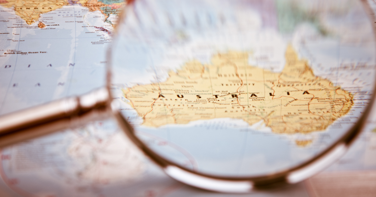 A magnifying glass zoomed in on a map of Australia. Contact our tax accountant in Sydney for assistance with tax planning and compliance for your business.