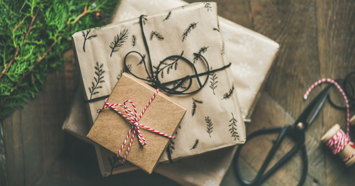 A stack of Christmas presents with different sizes and wrapping papers on top of each other. Make your Christmas wishes come true with the help of our small business accountants.