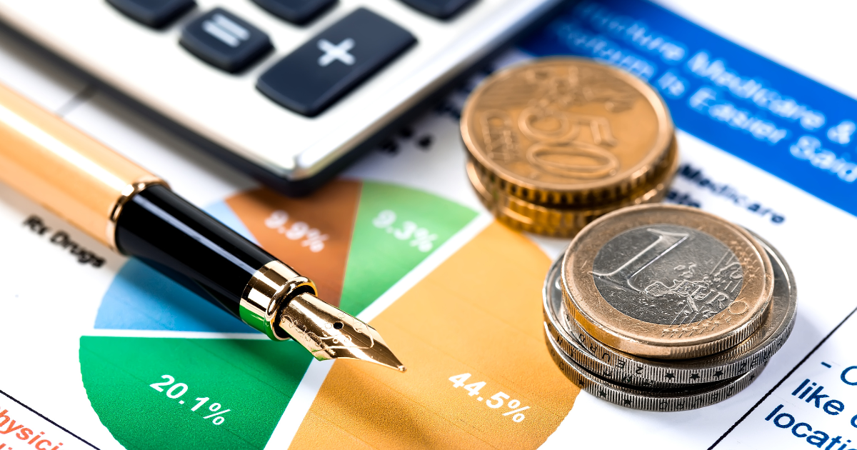 Financial data with a calculator, pen, and coins scattered on top. Trust our accounting firm in Sydney to provide you with accurate and reliable financial advice.