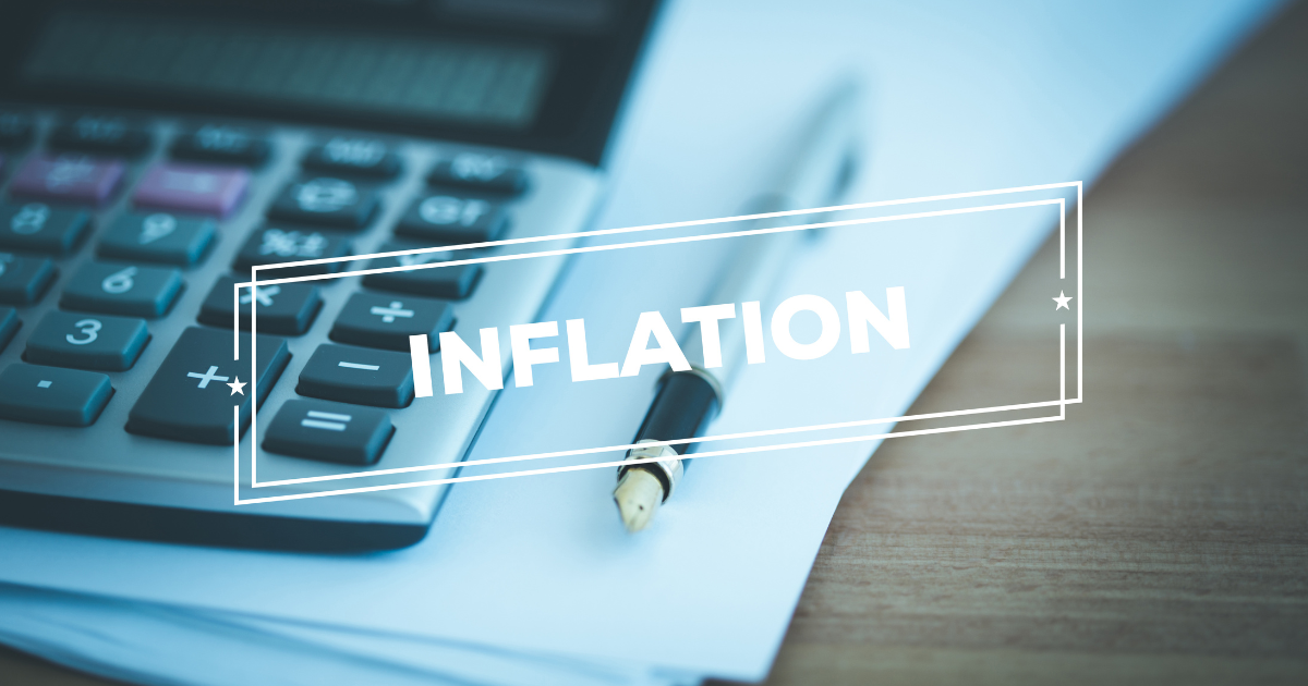 A business accountant's essential tools for coping with inflation include a calculator, documents, and a pen, with a subtle watermark of the word 'inflation' in the background.