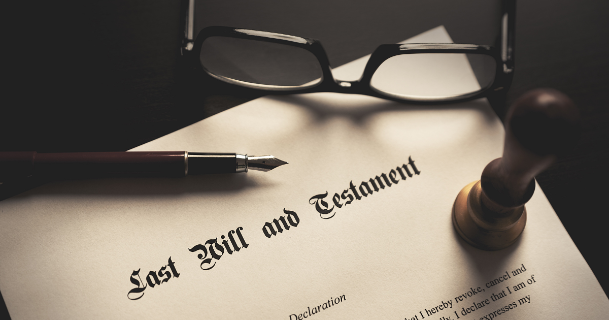 A last will and testament document, with an eyeglass, documentary stamp, and pen nearby. Our tax accountants can help you plan for the future and ensure your assets are protected.