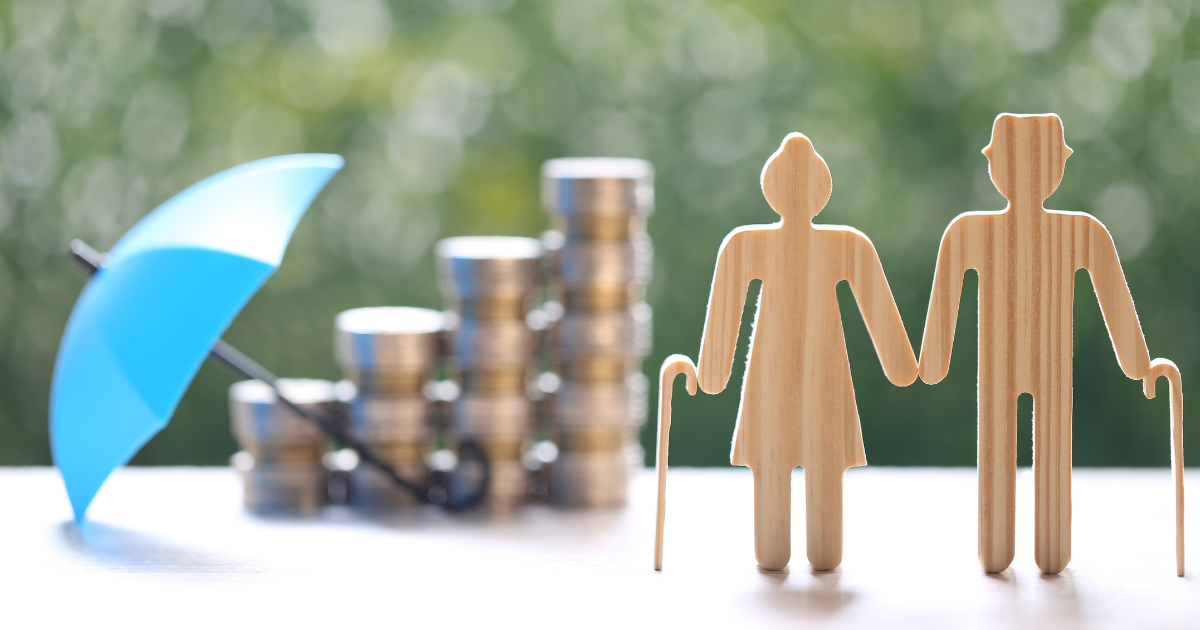 Two elderly figures standing in front of an umbrella and stacked coins. Trust our experienced small business accountants in Sydney to help you plan for a comfortable retirement.